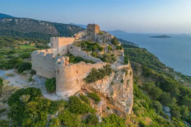 Kritinia Castle on its rocky crag above the western coast at golden hour