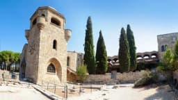 The bell tower of the Filerimos monastery among cypress trees