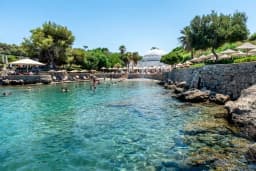The crystal-clear Kallithea Springs cove with the domed rotunda behind