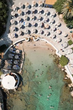 Swimmers in the turquoise water of the Kallithea Springs cove