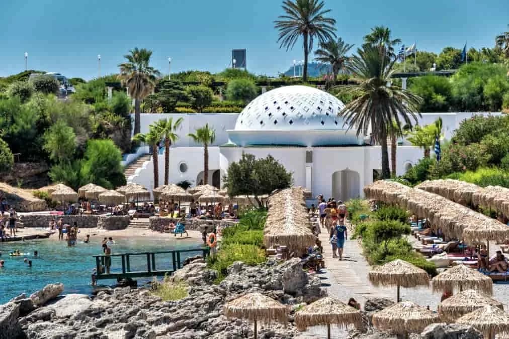 The white perforated dome of the Kallithea Springs Rotunda above the cove