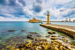 Mandraki harbour entrance with the bronze deer column and Fort St Nicholas