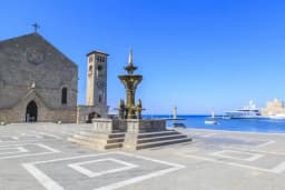Evangelismos church and the Mandraki fountain on the waterfront