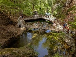 A wooden footbridge over the stream in the Valley of the Butterflies