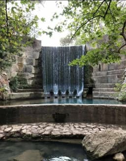 A waterfall spilling into the spring-fed pool at Seven Springs